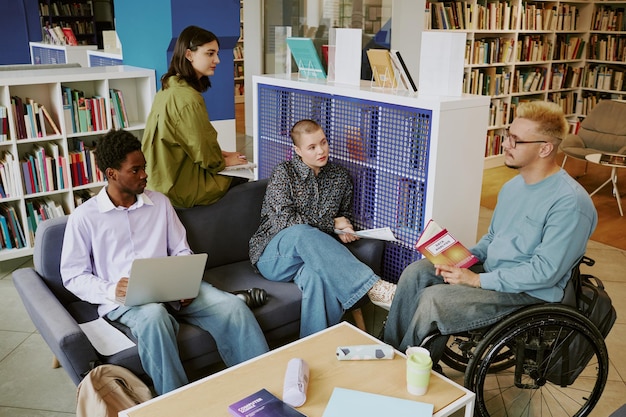 group diverse students studying library engaging discussion with textbooks laptops 249974 27245